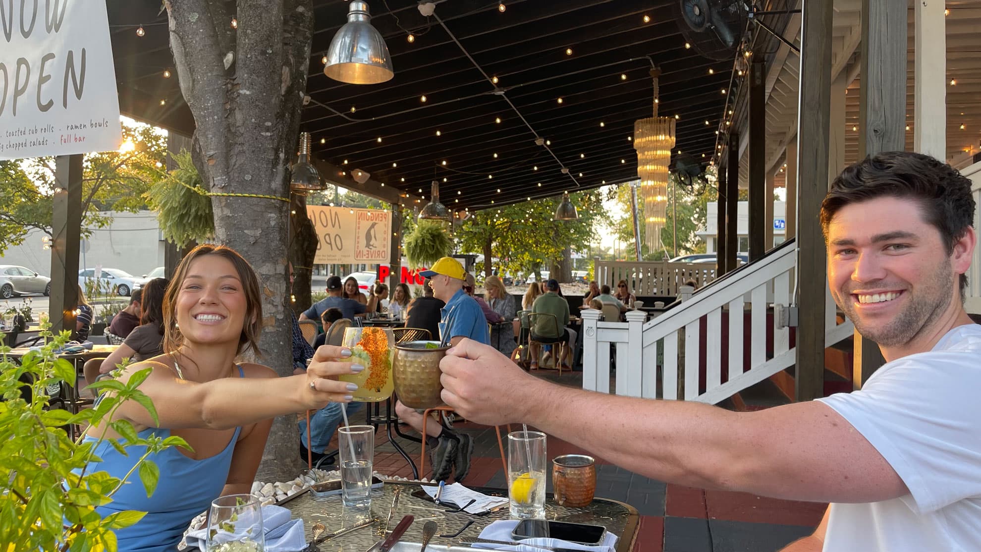 coupole toasting cocktails and beer on the patio